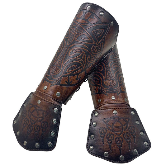 Pair of brown leather medieval bracers with embossed Viking knotwork and metal rivets